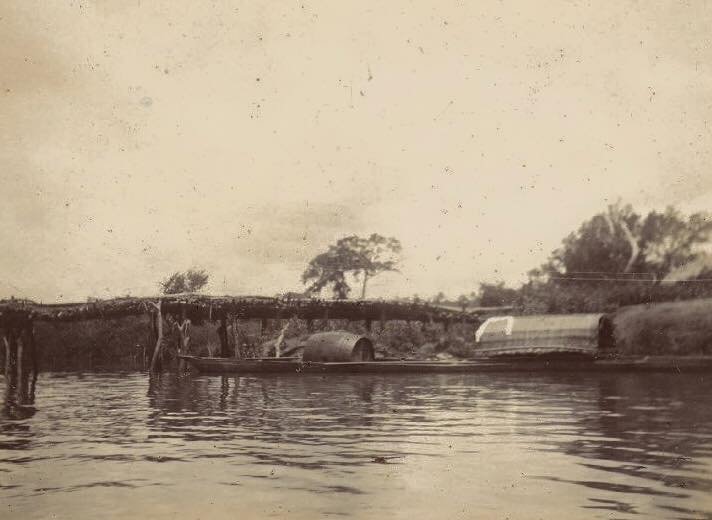 Bridge near Arochukwu with canoes passing under, 1903